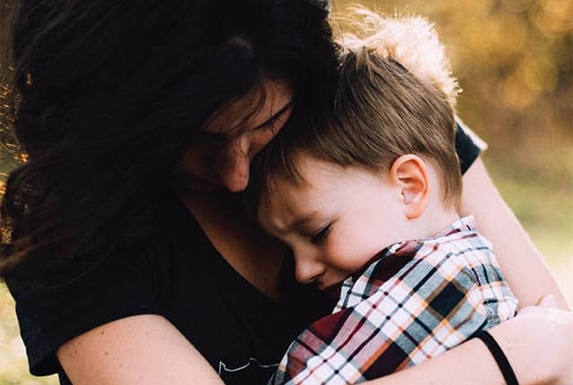 Mother holding her toddler son