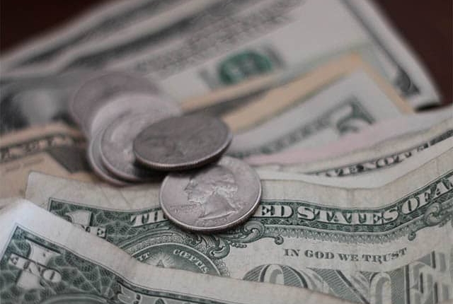 Closeup of dollar bills and change