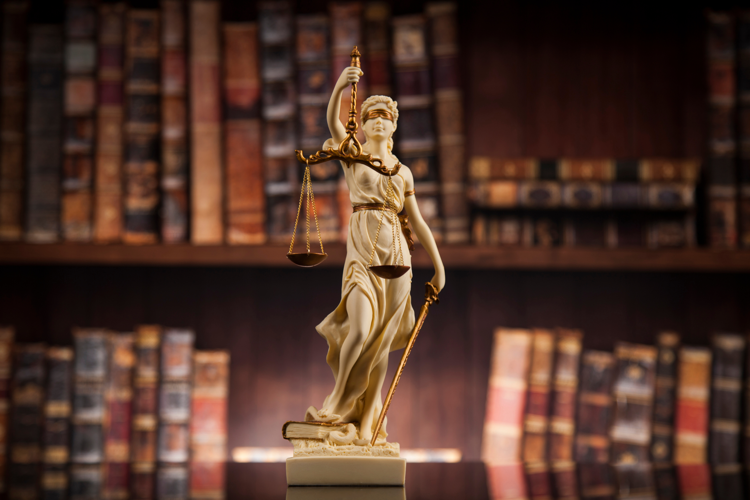 Judge gavel and scales of justice and book background